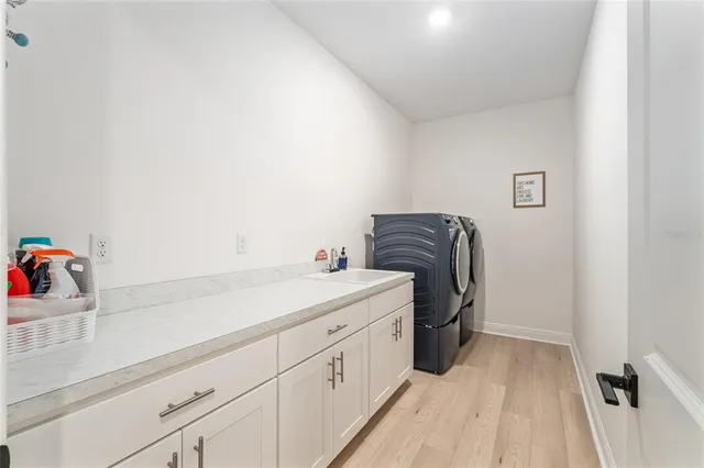 a utility room with a sink dryer and washer