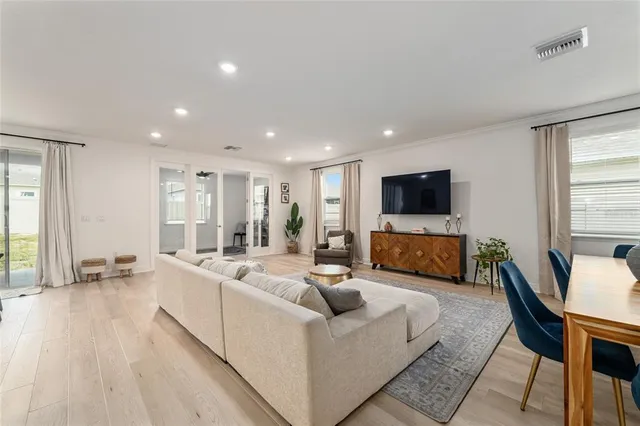 a living room with furniture wooden floor and a flat screen tv