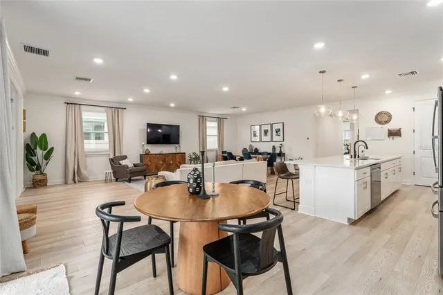 a kitchen with a dining table chairs and view living room