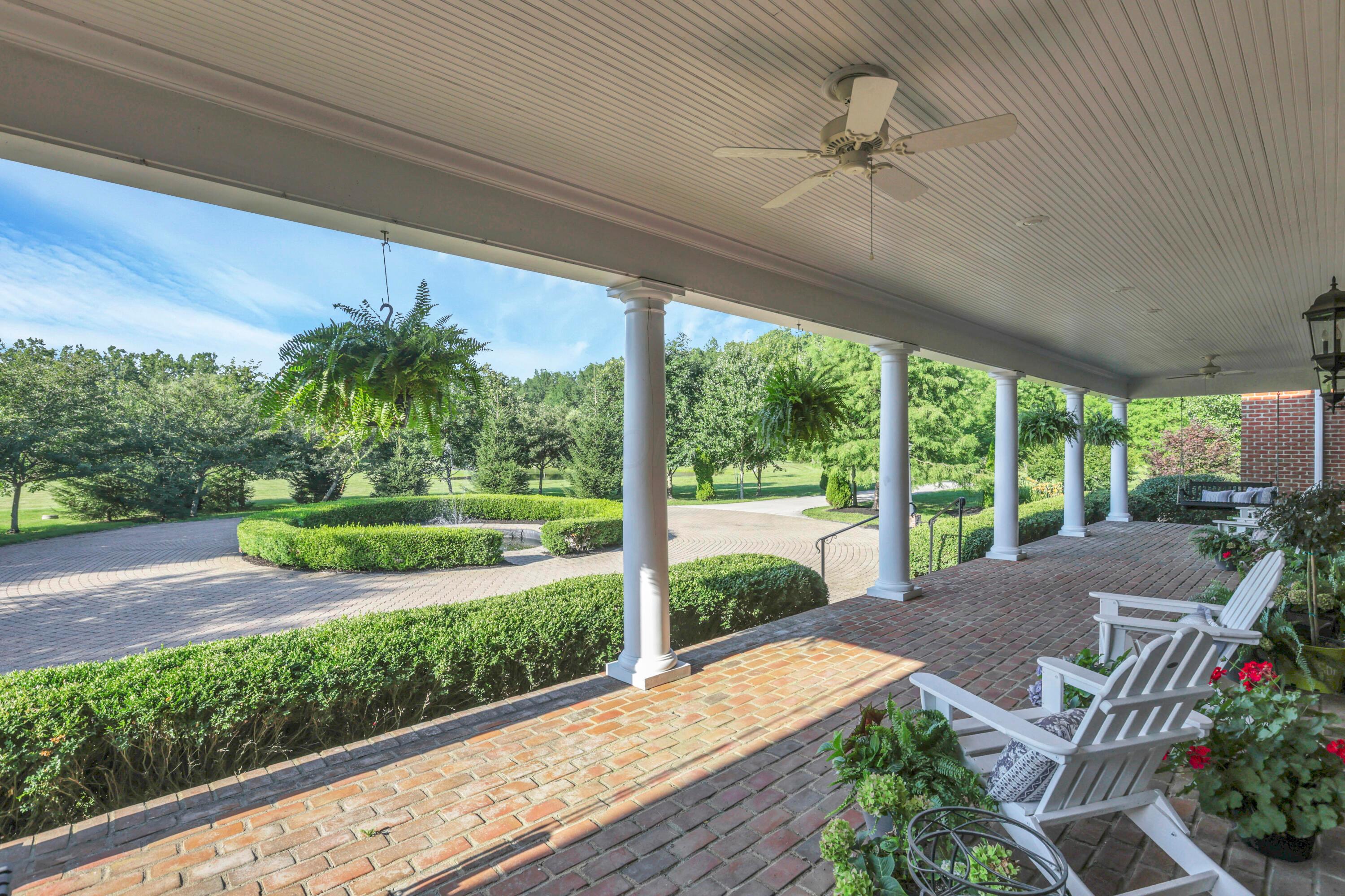 3575 State Rte 37 West Delaware, OH 43015 - Photo 5 of 106 Expansive covered porch featuring a brick surface, white columns, beadboard ceiling, and recessed lighting