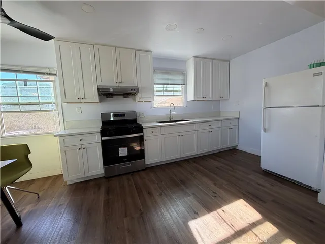 a kitchen with a sink a window and appliances