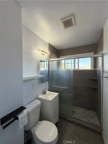 a bathroom with a toilet a sink and shower