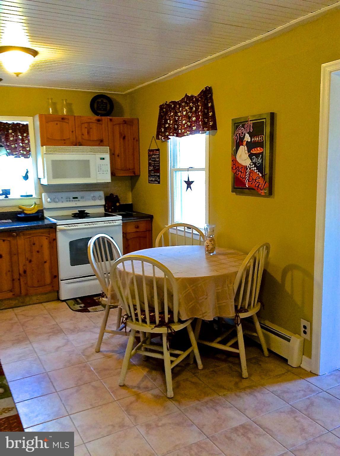 704 Kingfisher Road Deale, MD 20751 - Photo 8 of 27 a view of a dining room with furniture and a kitchen
