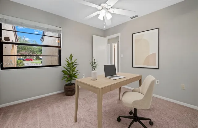 a view of a workspace with furniture and a potted plant