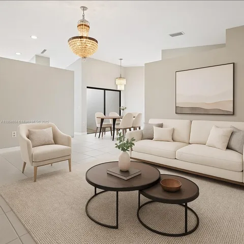 a living room with furniture a rug and kitchen view