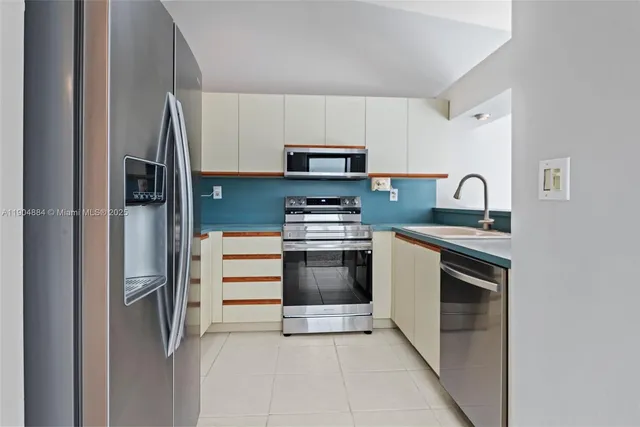 a kitchen with stainless steel appliances granite countertop a stove and a refrigerator