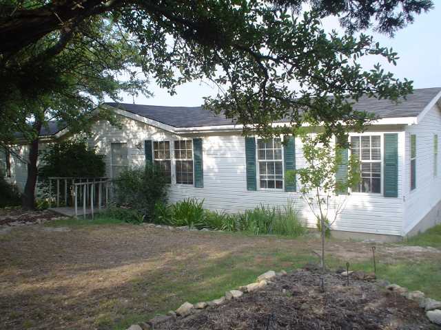 2500 Stagecoach Ranch Loop Dripping Springs, TX 78620 - Photo 1 of 1 a front view of a house with garden