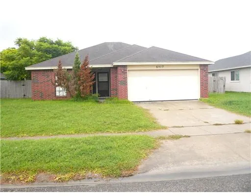 a view of a house with a yard and a garage