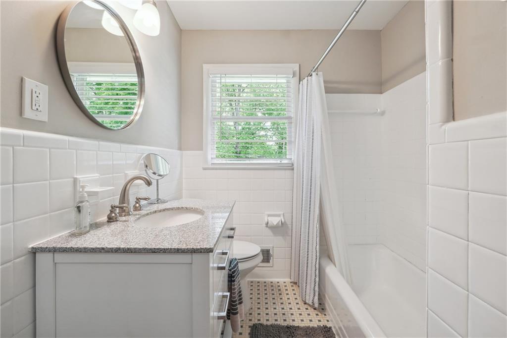 3483 Glensford Drive Decatur, GA 30032 - Photo 13 of 24 a bathroom with a granite countertop sink a toilet and a mirror