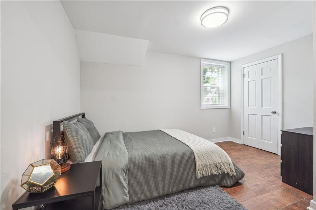 3483 Glensford Drive Decatur, GA 30032 - Photo 22 of 24 a bedroom with a bed and wooden floor