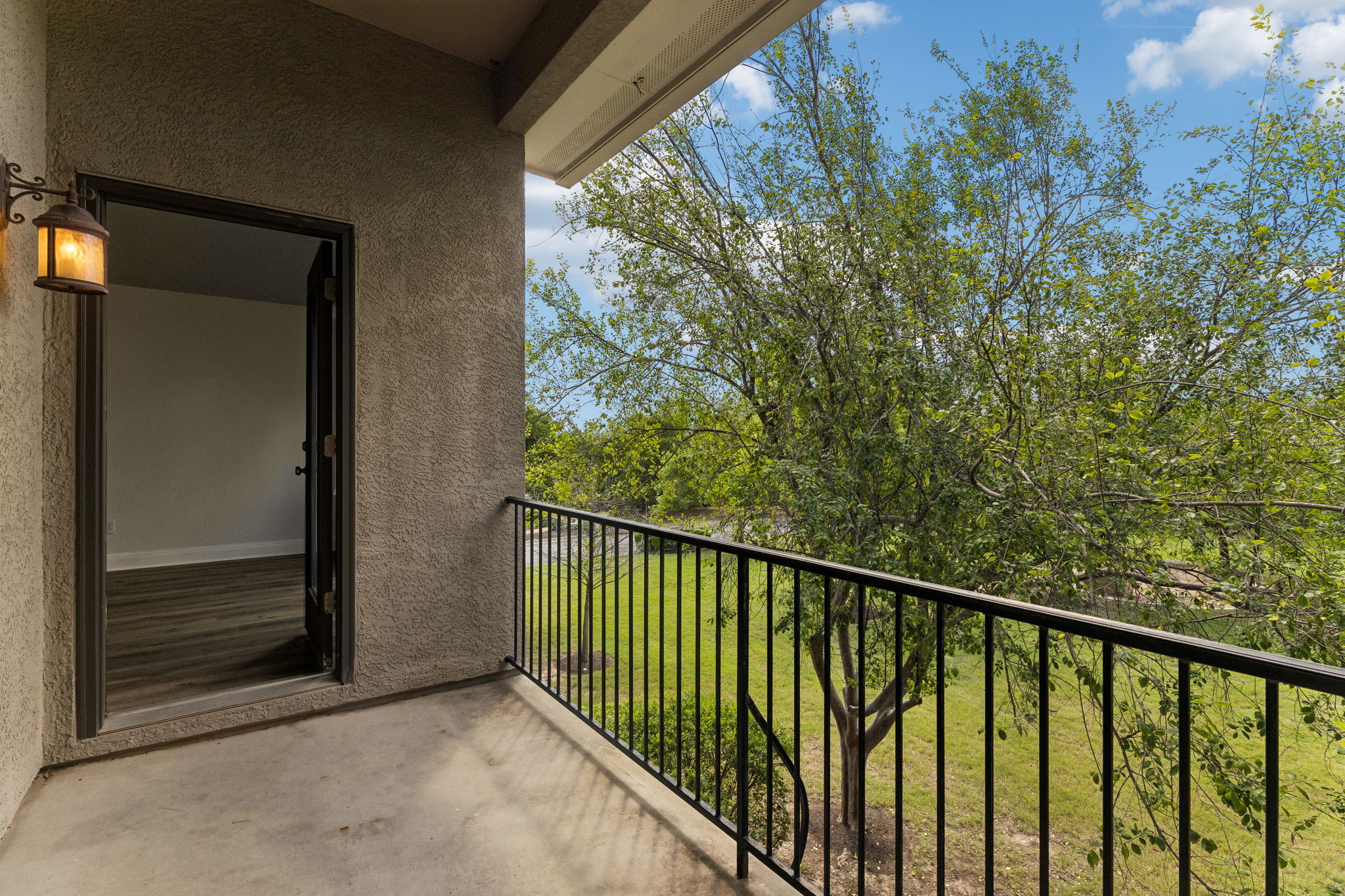 114 Aria Ridge, Unit 802 Lakeway, TX 78738 - Photo 32 of 37 An inviting balcony overlooks a verdant landscape, perfect for serene outdoor moments.