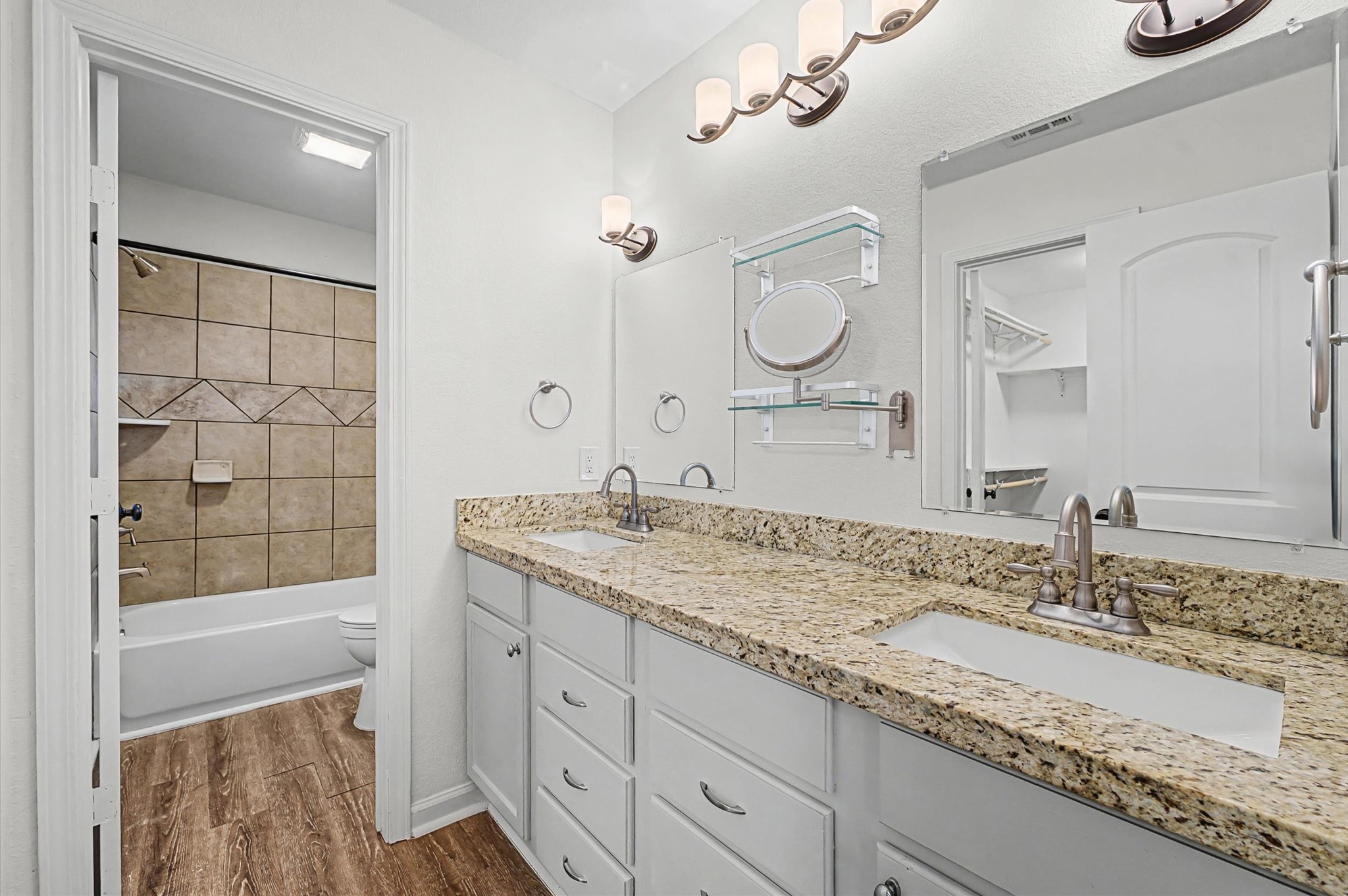 3812 Hardin Road Baytown, TX 77521 - Photo 14 of 30 A primary bath designed for comfort and charm, complete with double sinks and granite countertops.