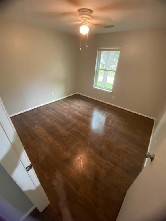 5710 Glenmere Lane Spring, TX 77379 - Photo 6 of 9 wooden floor in an empty room with a window
