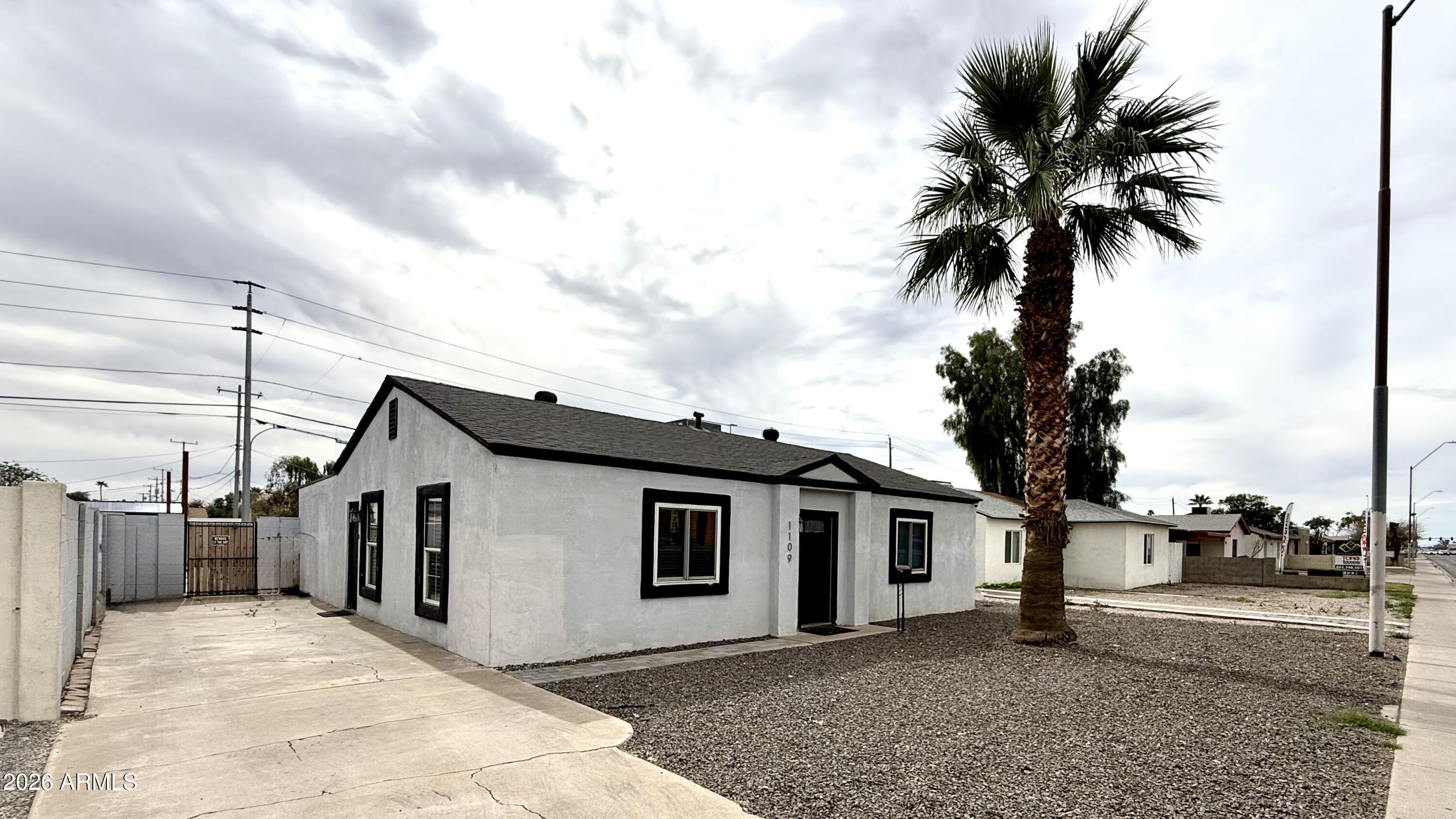 1109 West Indian School Road Phoenix, AZ 85013 - Photo 5 of 38 a front view of a house with a yard