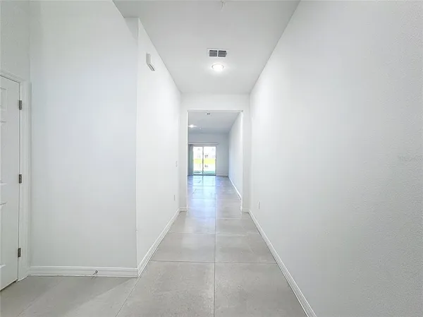 an empty room with entrance and windows