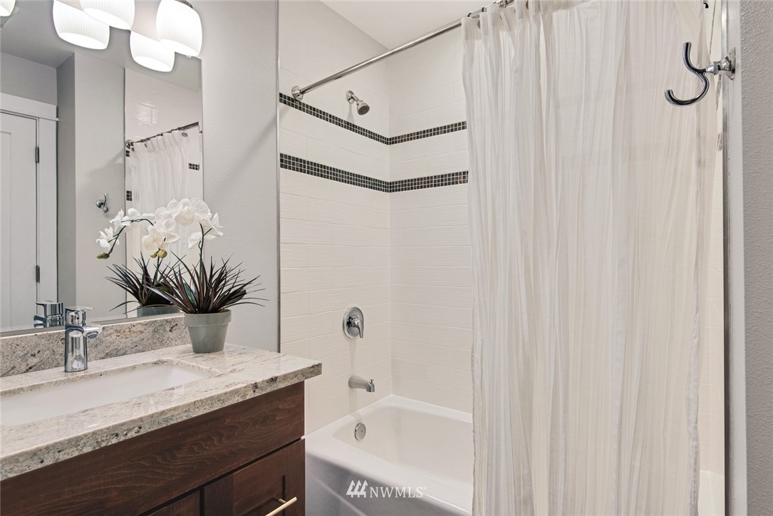 3617 Geyer Lane Everett, WA 98203 - Photo 16 of 23 a bathroom with a granite countertop sink and a mirror