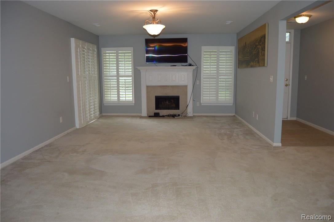 3703 Oakmonte Boulevard Rochester, MI 48306 - Photo 3 of 23 Spacious living room with walk out to patio and plantation shutters