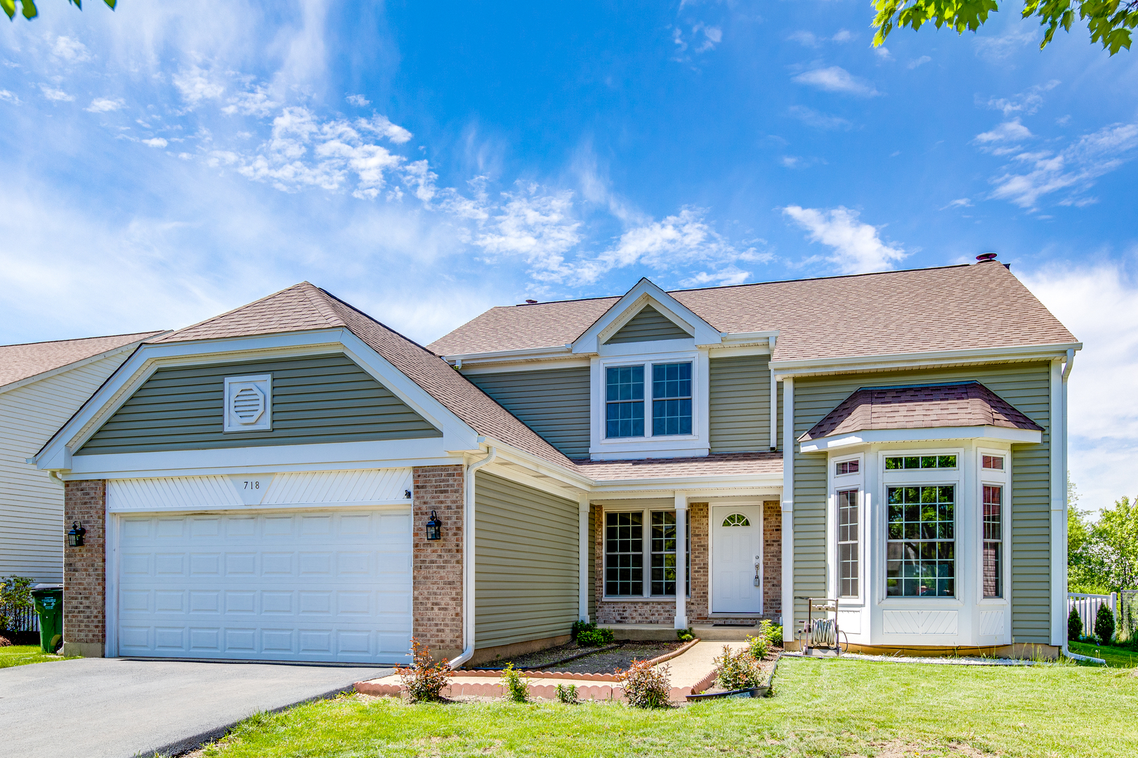 718 Huntington Drive Carol Stream, IL 60188 - Photo 1 of 28 a front view of a house with a yard