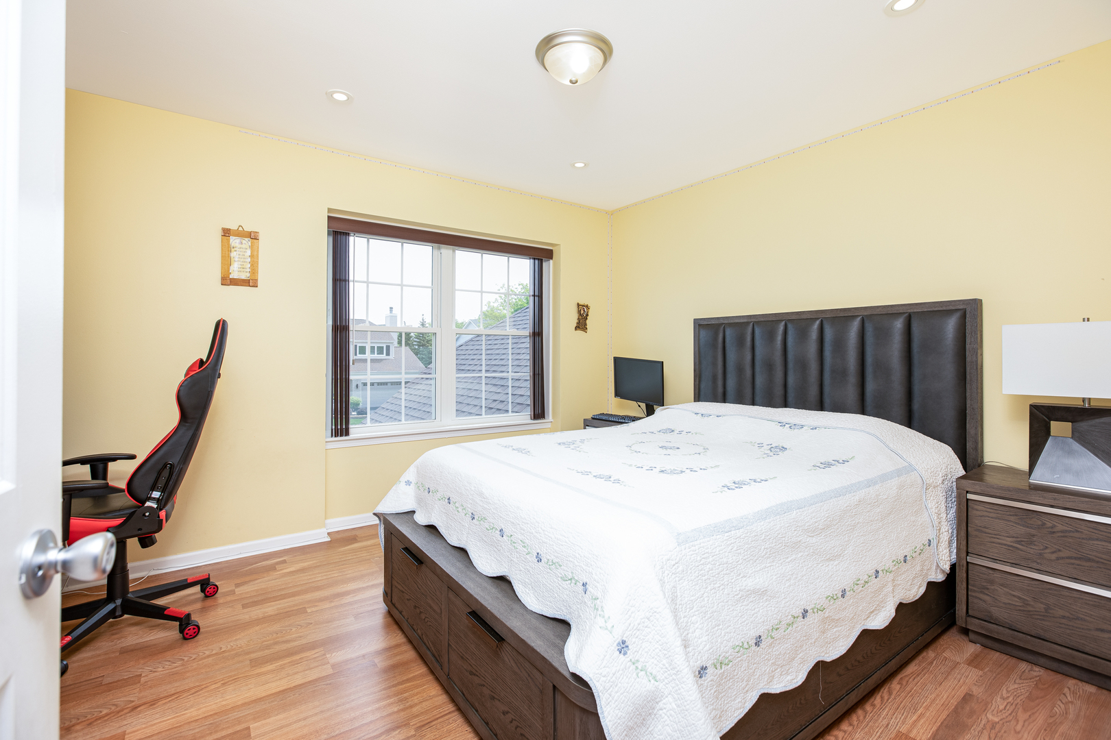 718 Huntington Drive Carol Stream, IL 60188 - Photo 15 of 28 a bed sitting in a bedroom next to a window