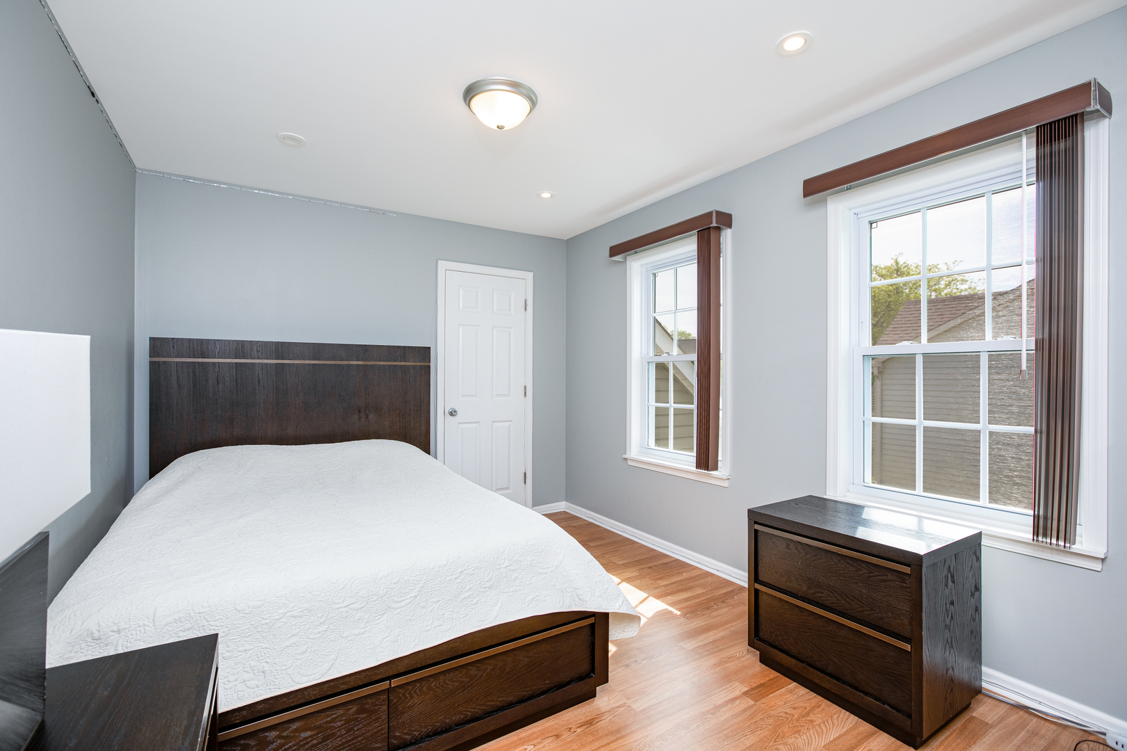 718 Huntington Drive Carol Stream, IL 60188 - Photo 17 of 28 a bedroom with a bed and wooden floor