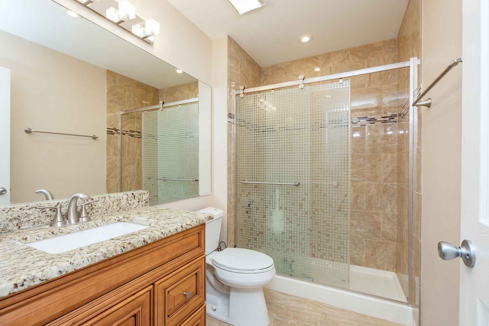 718 Huntington Drive Carol Stream, IL 60188 - Photo 18 of 28 a bathroom with a granite countertop sink toilet and shower