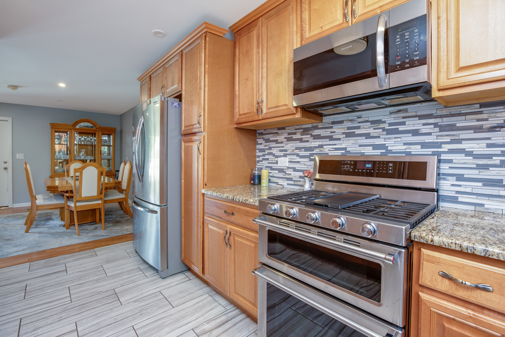 718 Huntington Drive Carol Stream, IL 60188 - Photo 8 of 28 a kitchen with wooden cabinets and a stove top oven