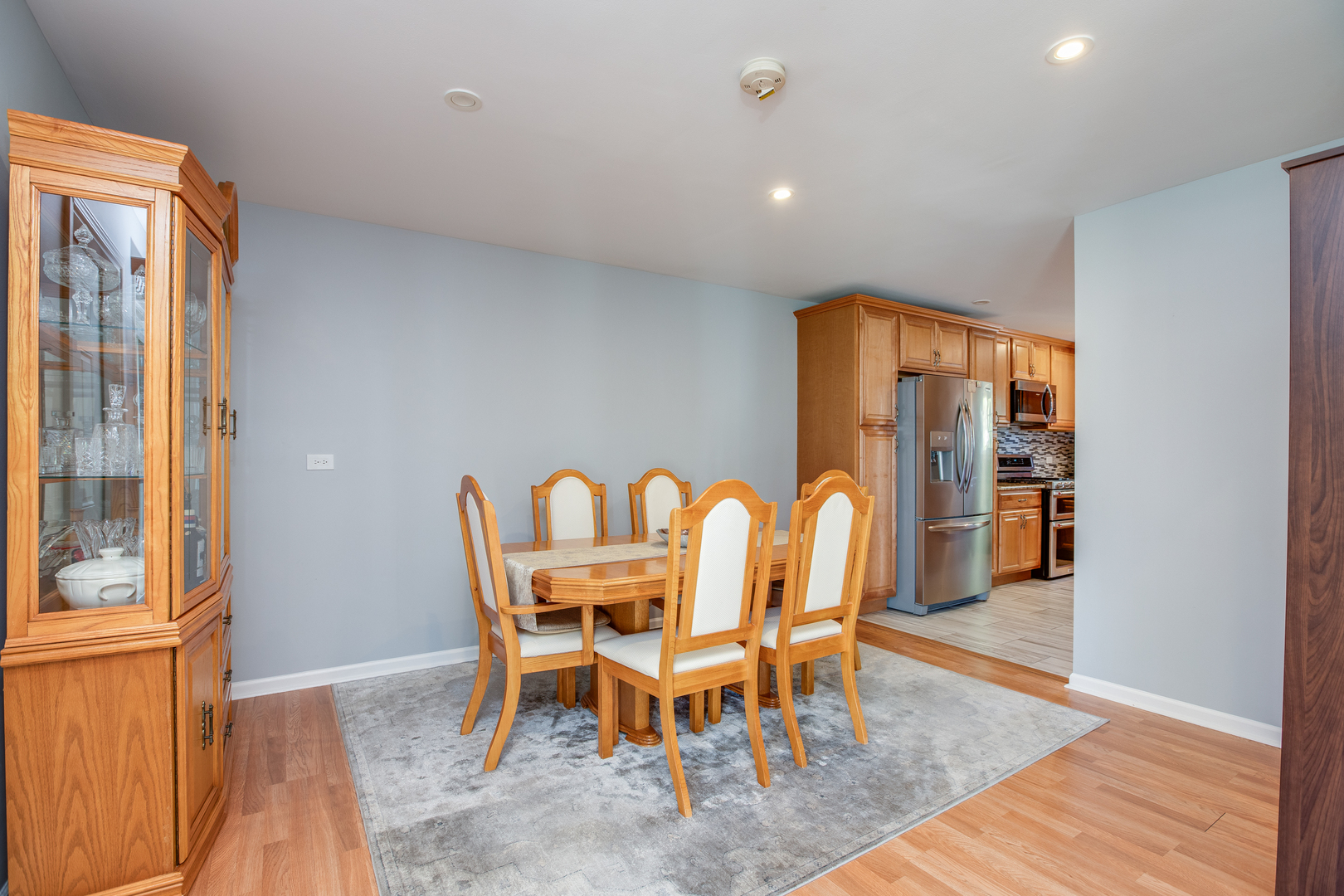 718 Huntington Drive Carol Stream, IL 60188 - Photo 10 of 28 a dining room with furniture and wooden floor