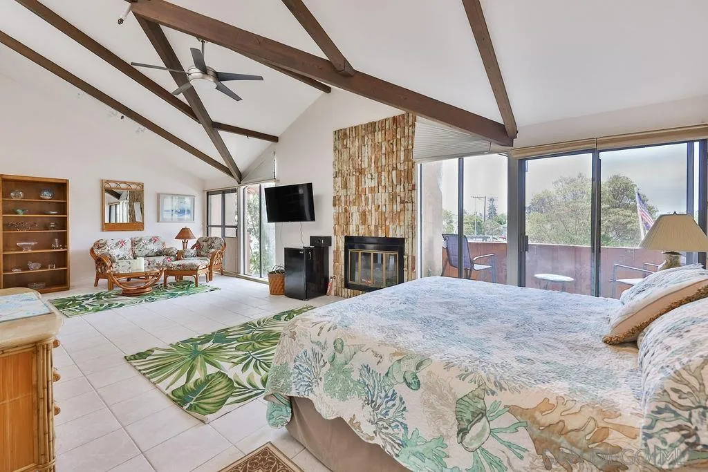 835 D Avenue, Unit 4 Coronado, CA 92118 - Photo 20 of 35 a large bedroom with furniture large window and flat screen tv