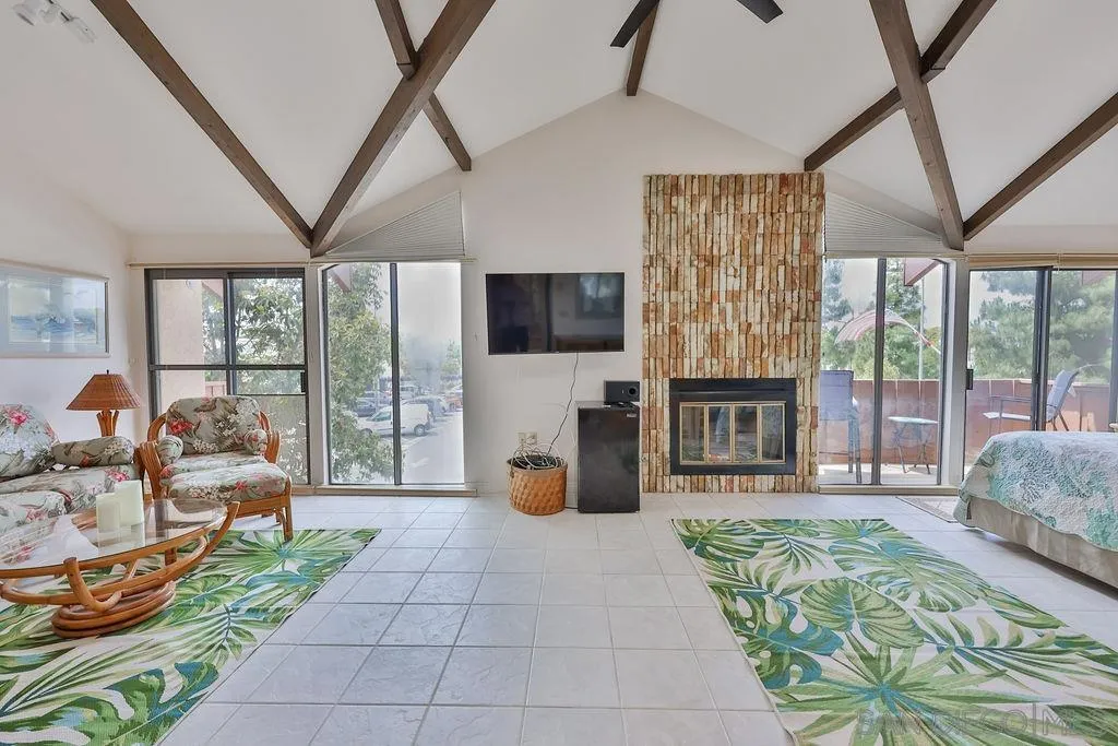 835 D Avenue, Unit 4 Coronado, CA 92118 - Photo 23 of 35 a living room with patio furniture and a flat screen tv