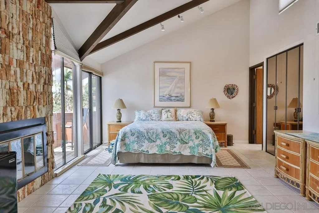 835 D Avenue, Unit 4 Coronado, CA 92118 - Photo 25 of 35 a spacious bedroom with a large bed and a chandelier