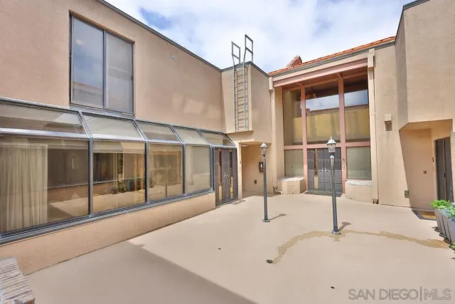 a view of building with roof deck and seating space