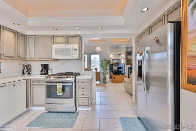 a kitchen with stainless steel appliances granite countertop a refrigerator and a stove top oven