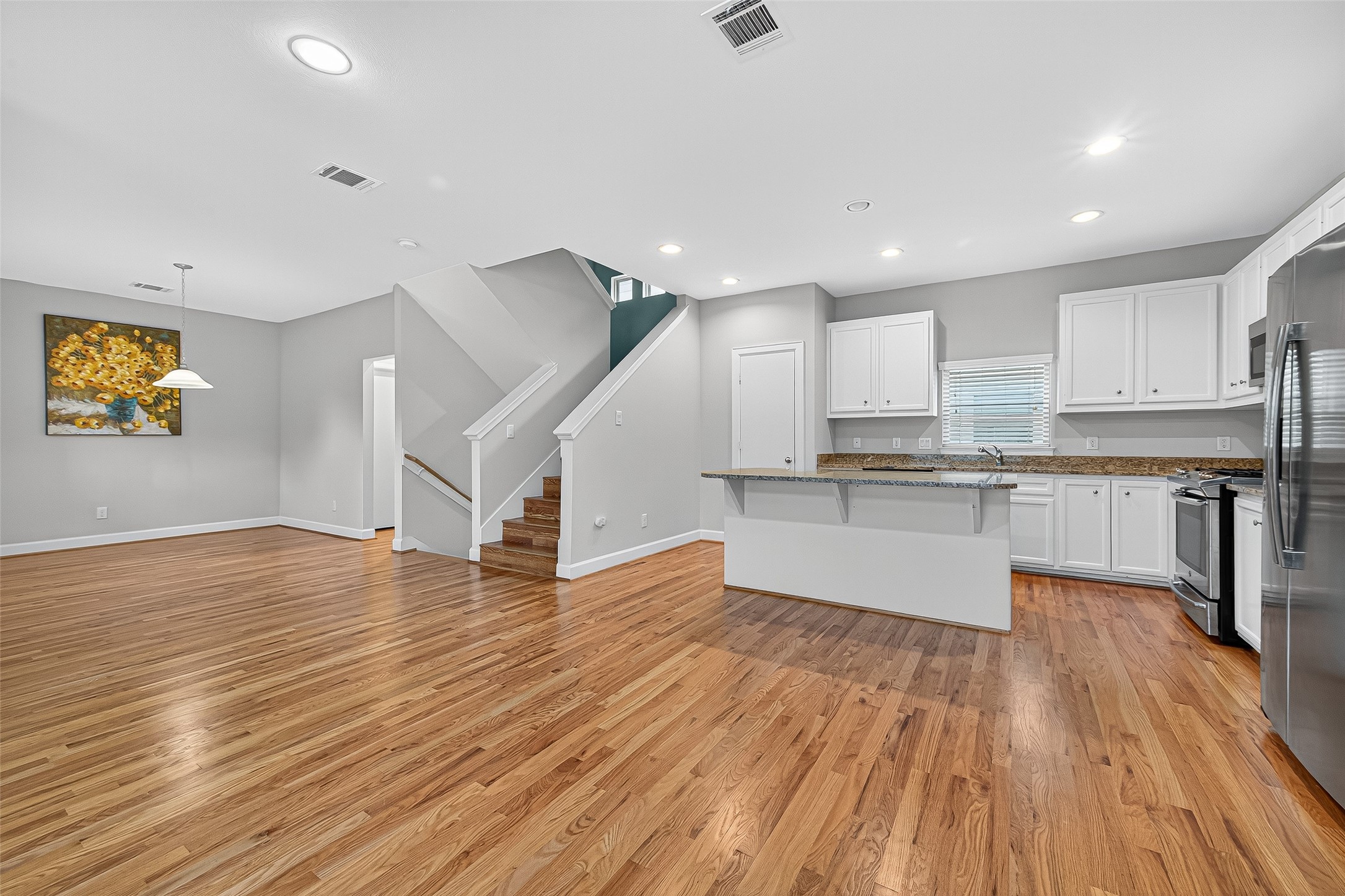 11510 Main Ash Drive Houston, TX 77025 - Photo 14 of 39 a view of kitchen with cabinets stainless steel appliances and wooden floor