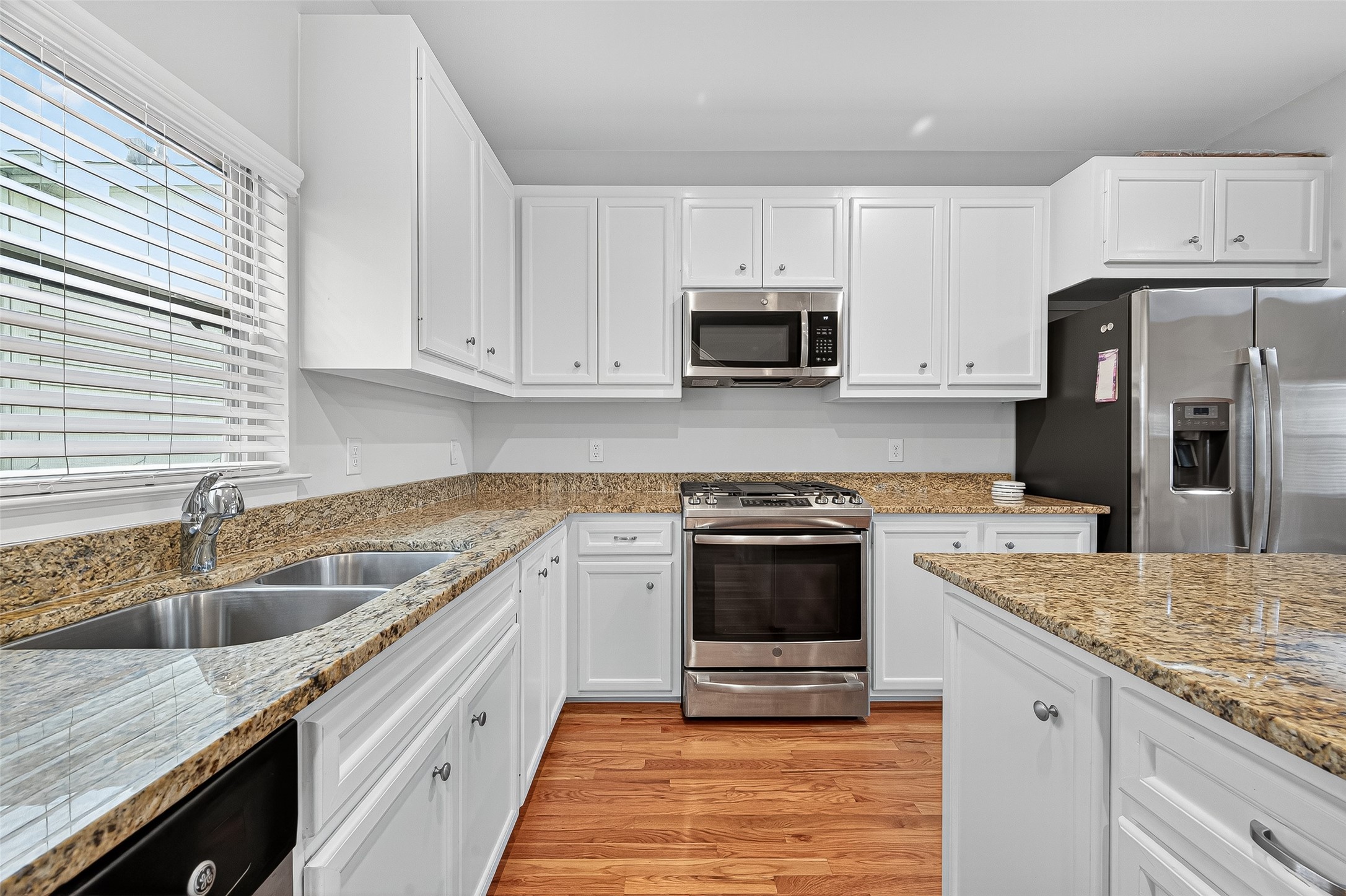 11510 Main Ash Drive Houston, TX 77025 - Photo 22 of 39 a kitchen with granite countertop a sink stove and refrigerator
