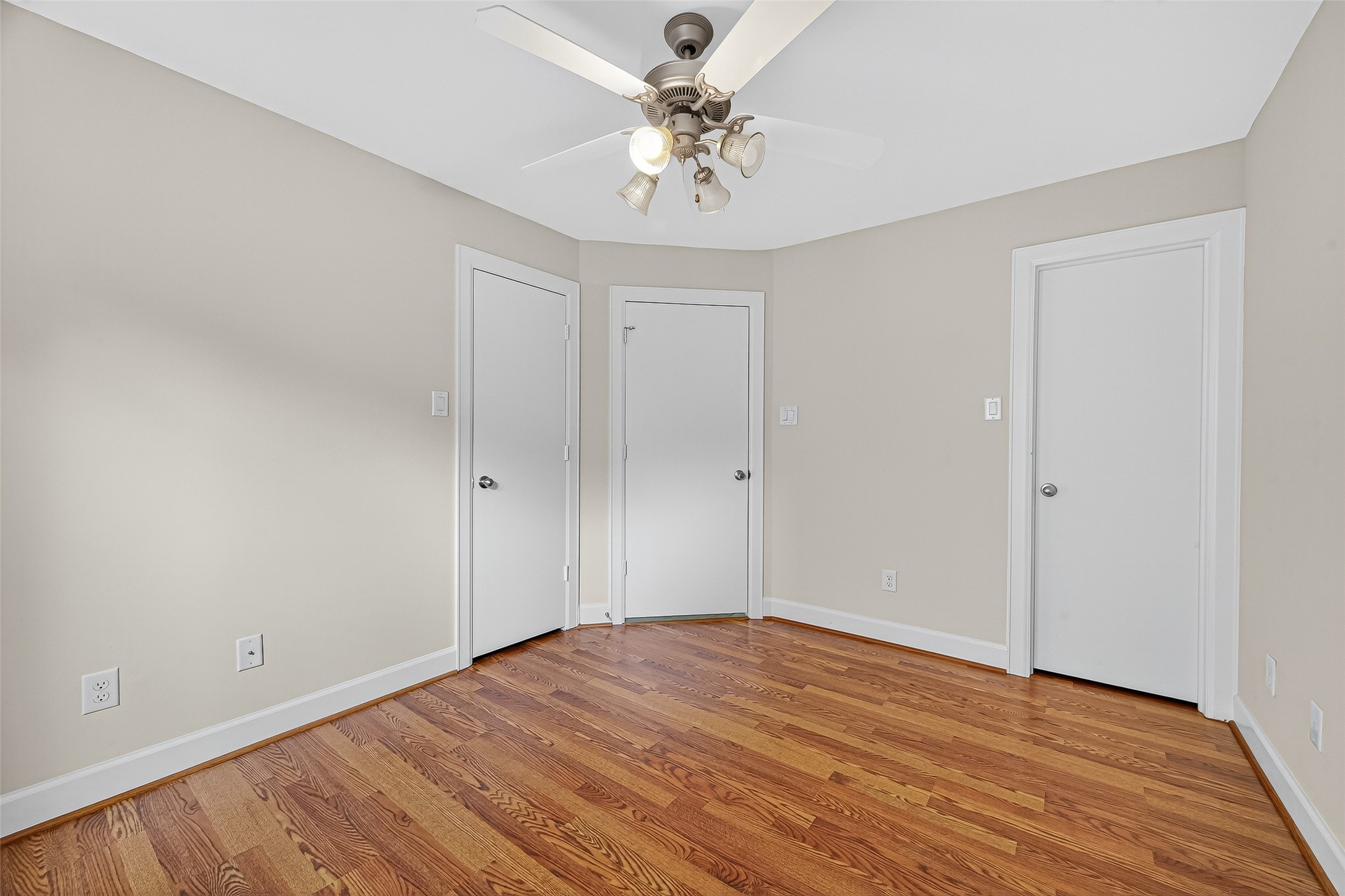 11510 Main Ash Drive Houston, TX 77025 - Photo 24 of 39 a view of a room with wooden floor and a ceiling fan