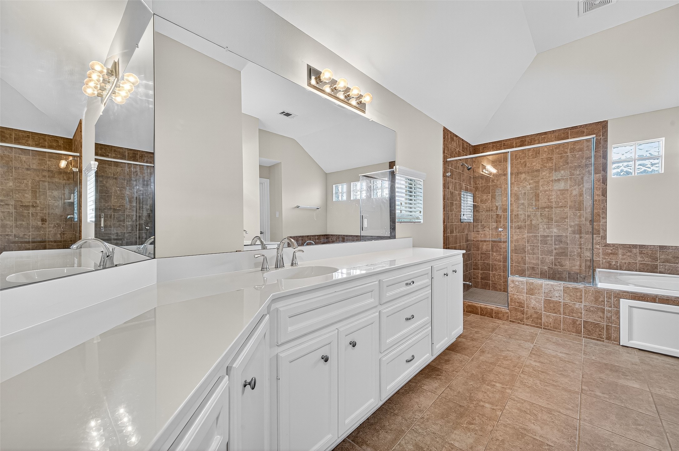 11510 Main Ash Drive Houston, TX 77025 - Photo 33 of 39 a bathroom with a double vanity sink a toilet a mirror and shower