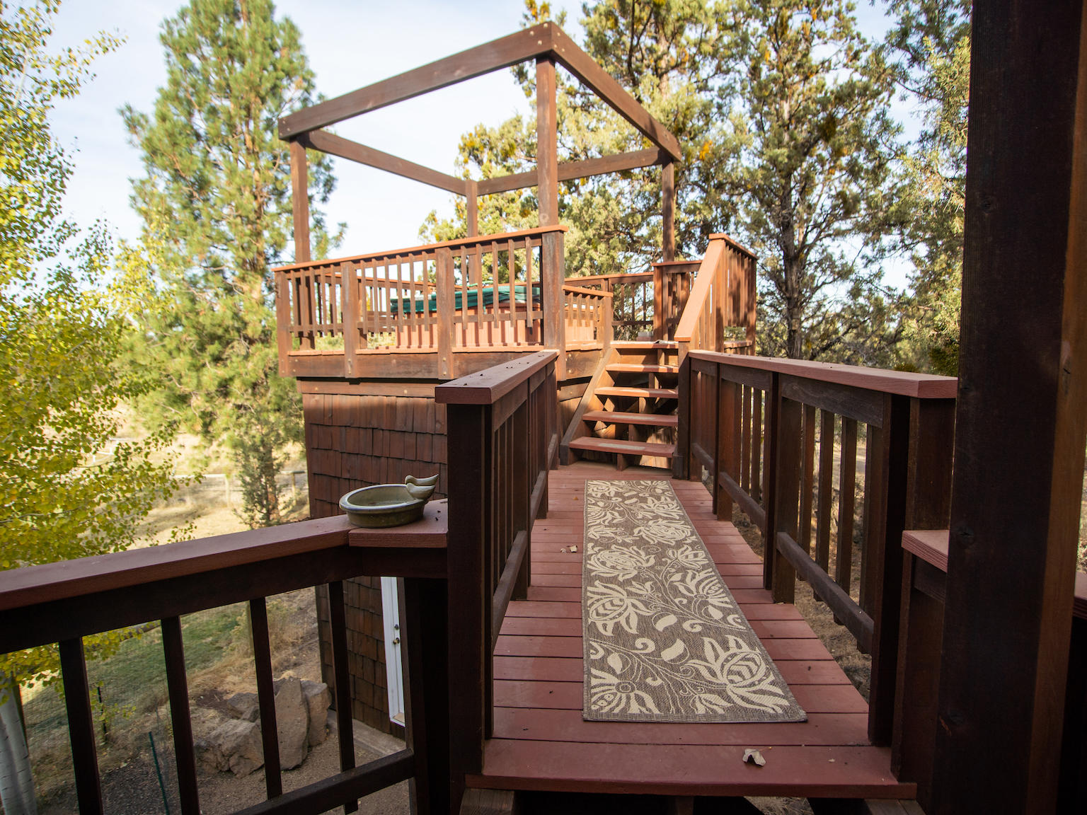 64295 Schibel Road Bend, OR 97703 - Photo 27 of 41 a view of balcony with wooden floor and outdoor seating