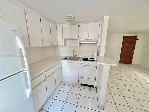 a kitchen with cabinets and appliances
