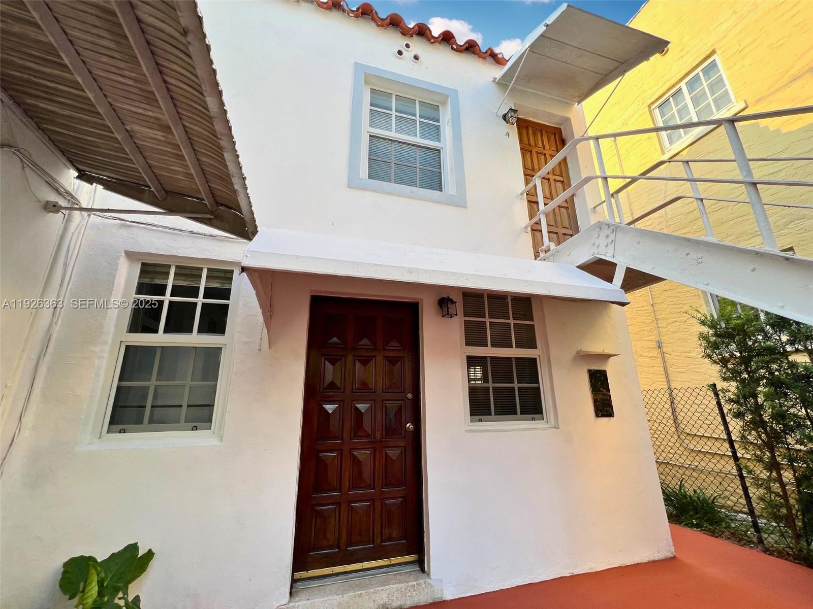 227 Phoenetia Avenue, Unit 3 Coral Gables, FL 33134 - Photo 10 of 10 a front view of a house with a yard