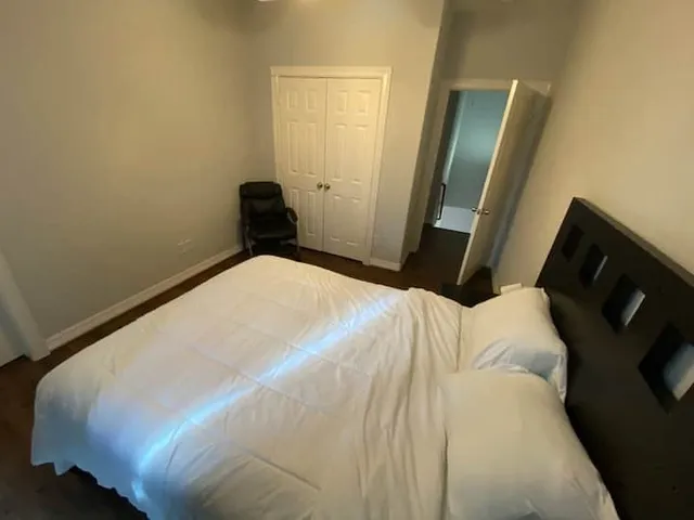 a bedroom with a bed and a mirror