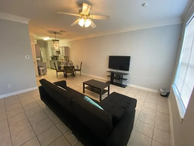 a living room with furniture and a flat screen tv