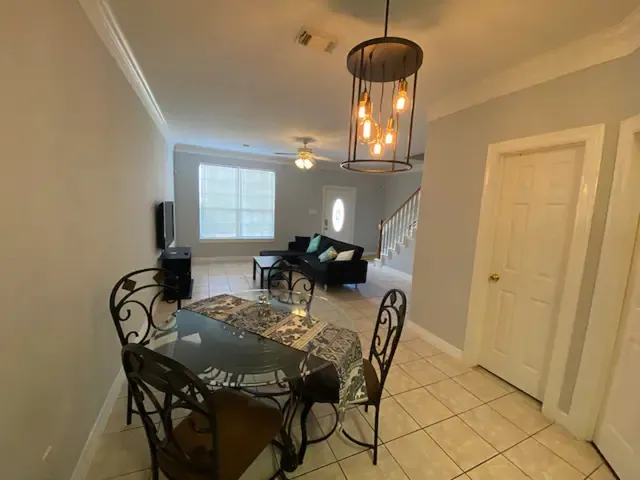 a view of a dining room with furniture and chandelier