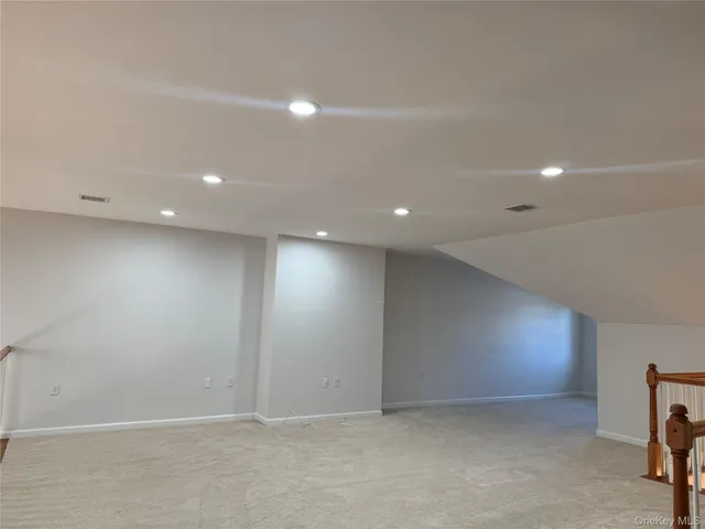 an empty room with a projector and screen