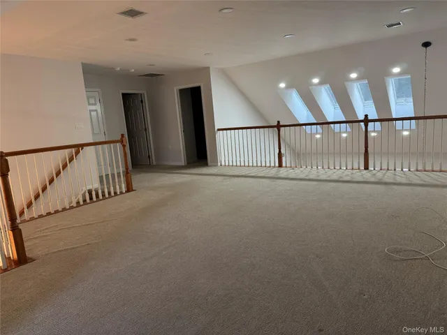 a view of a hallway with stairs