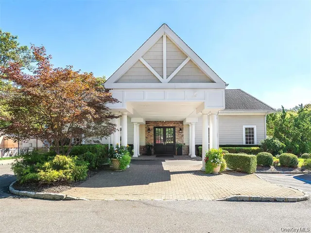 a view of a house with a yard and potted plants