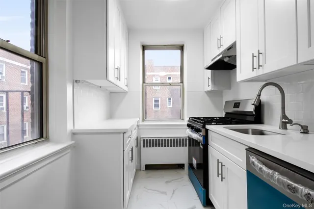 a close view of a sink a faucet and cabinets in a kitchen