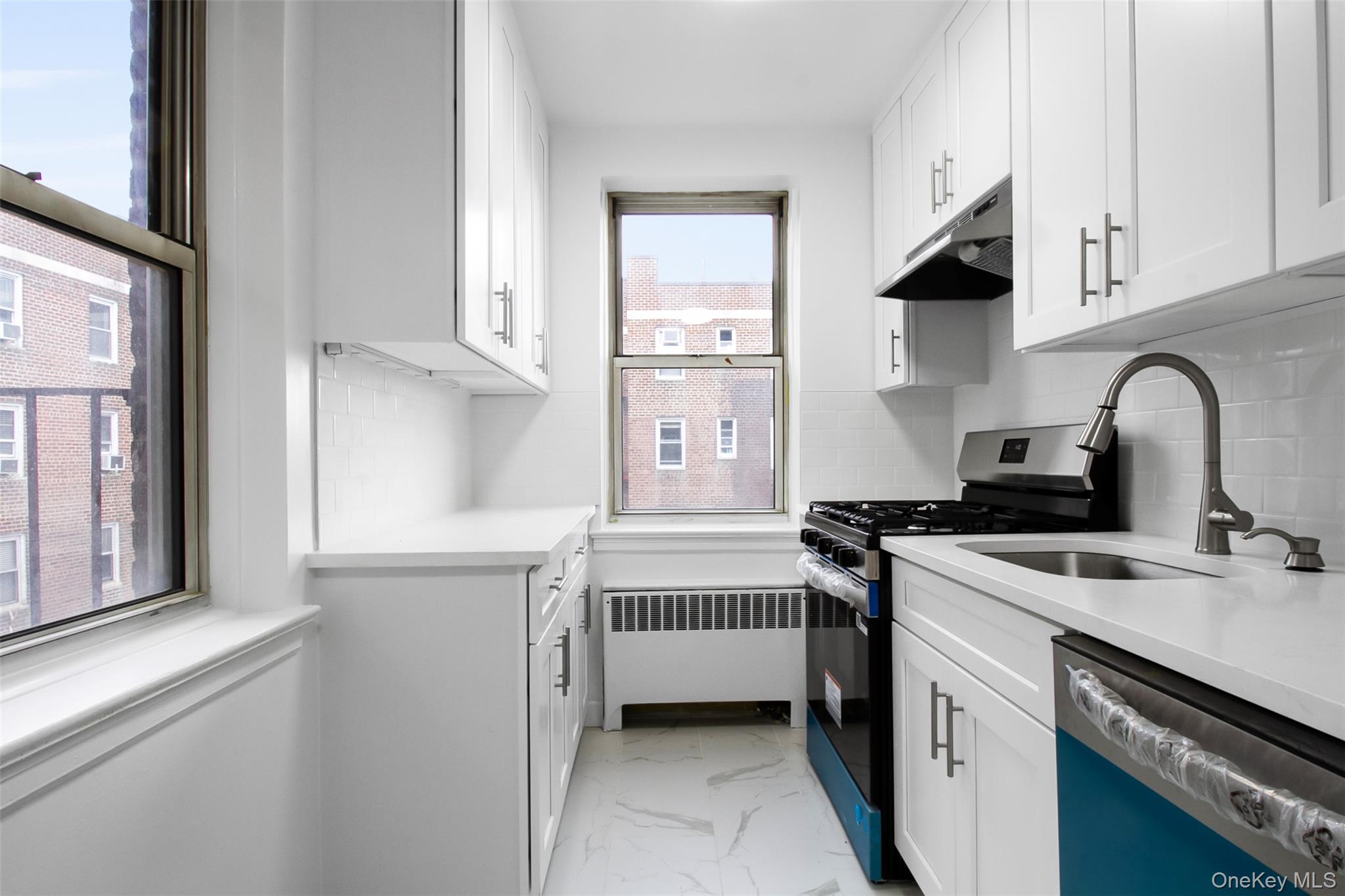 485 Bronx River Road, Unit A50 Yonkers, NY 10704 - Photo 11 of 23 a kitchen with stainless steel appliances a sink stove and cabinets
