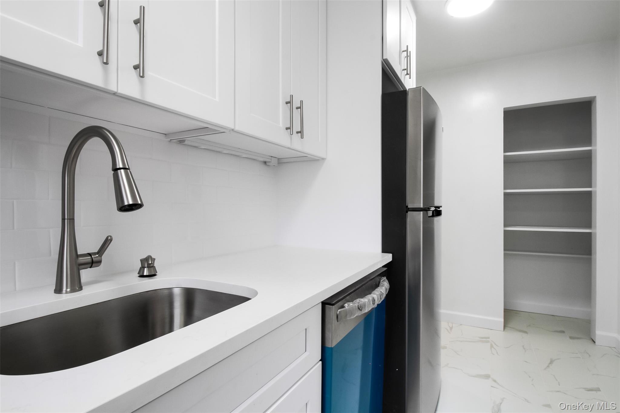 485 Bronx River Road, Unit A50 Yonkers, NY 10704 - Photo 12 of 23 a close view of a sink a faucet and cabinets in a kitchen