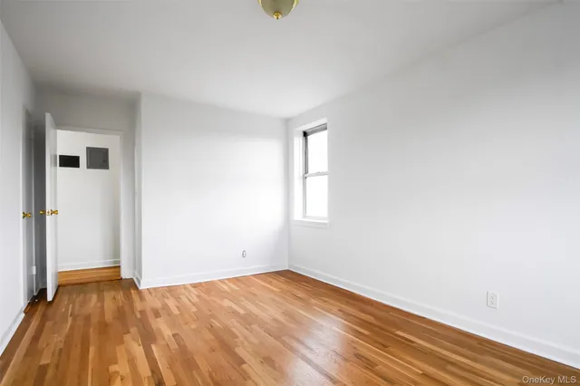 a view of a room with wooden floor