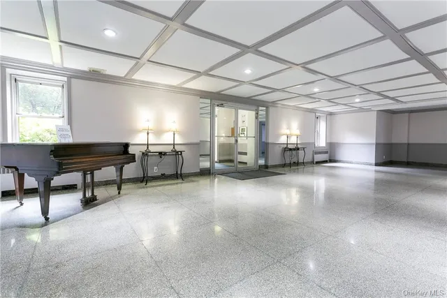 a area with lots of furniture and a chandelier